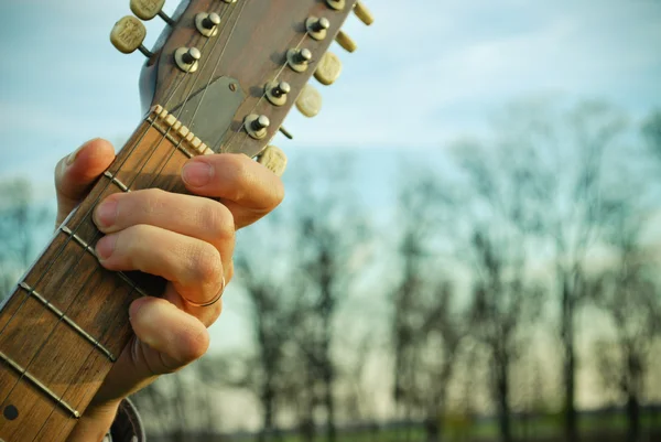 Holding a guitar — Stock Photo, Image