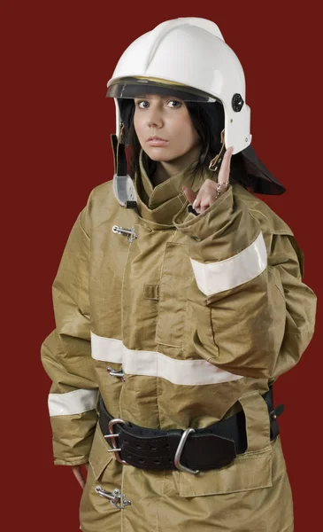 Meisje in brandweerman uniform — Stockfoto