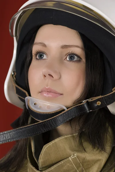 Girl in fireman uniform upstairs — Stock Photo, Image