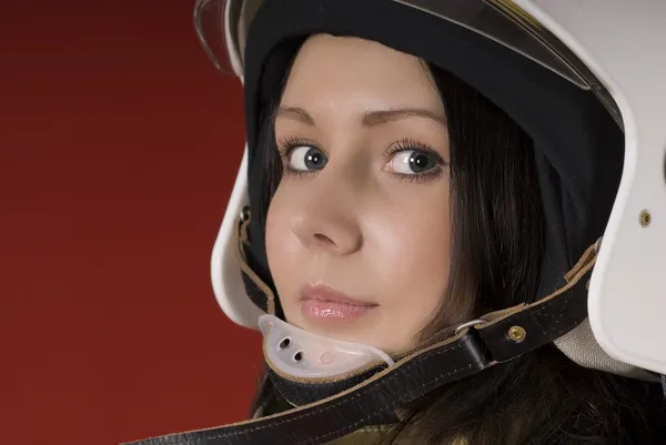 Meisje in brandweerman uniform boven — Stockfoto