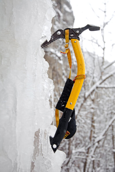 Climbing ice ax in the white ice