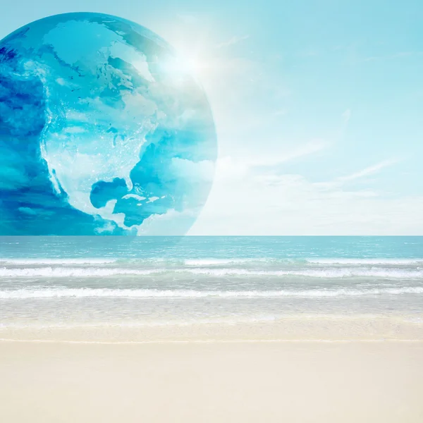 stock image America globe on tropical beach. Map from NASA imagery