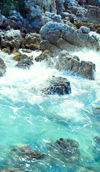 Surf on stones near island — Stock Photo, Image