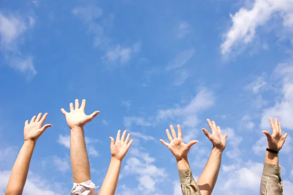 stock image Hands rised up in air across sky