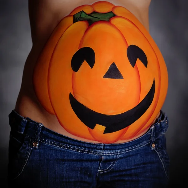 Halloween pumpkin painted on belly of pregnant — Stock Photo ...