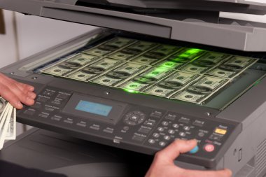 Fake money on copy machine in office clipart