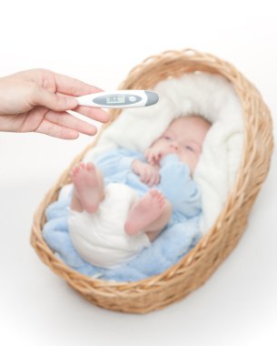 Newborn baby in basket with temperature meter clipart