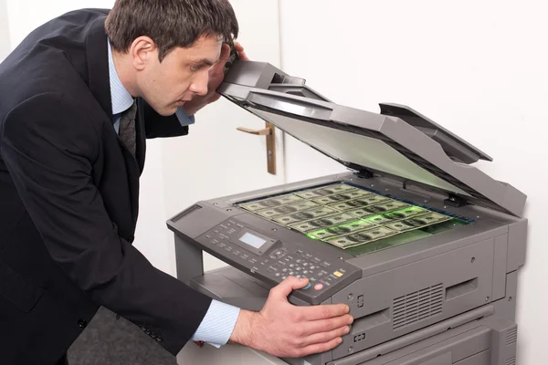 Businessman make false money on copy machine — Stock Photo, Image