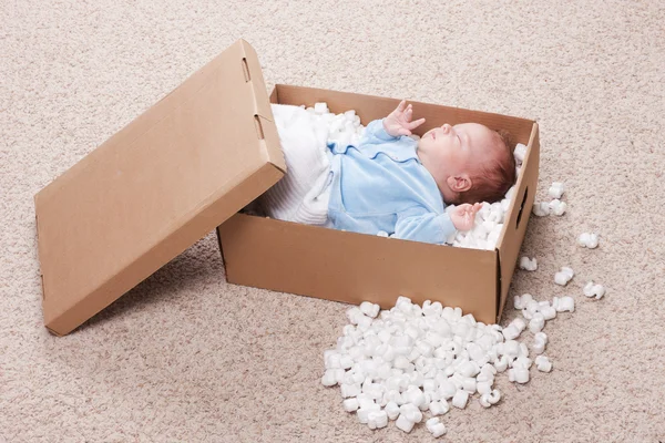 Newborn baby in open post box — Stock Photo, Image