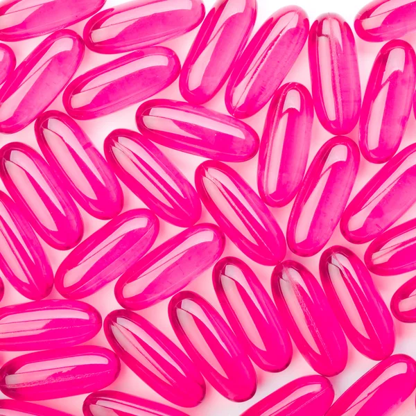 Pink capsules on white background — Stock Photo, Image