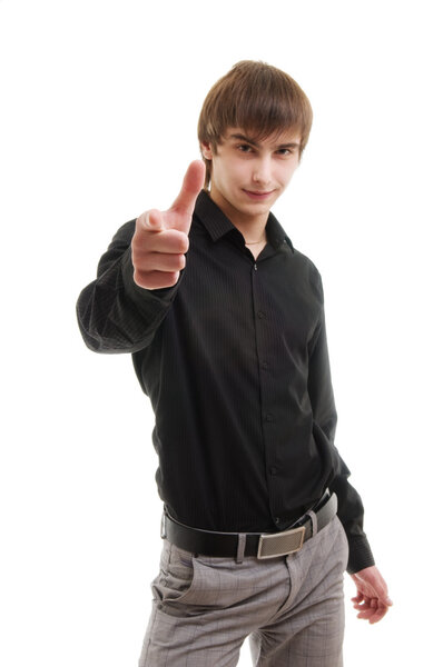 Young man pointing at camera. Isolated over white.
