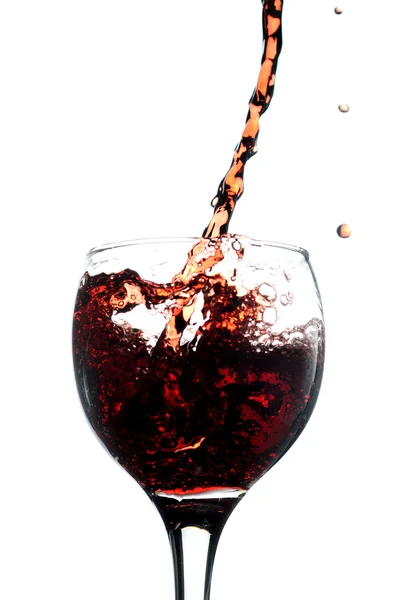 Red wine pouring in glass. Isolated over white — Stock Photo, Image