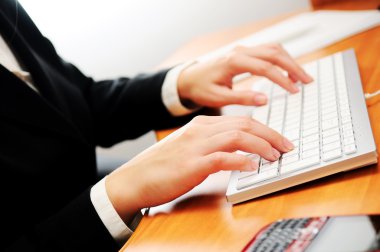 Female hands typing on a keyboard clipart