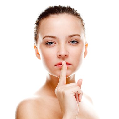 Beautiful woman making silence sign. Isolated over white. Focused on finger clipart