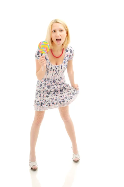 Attraktiva förvånad blondin med lollipop håller hennes klänning — Stockfoto