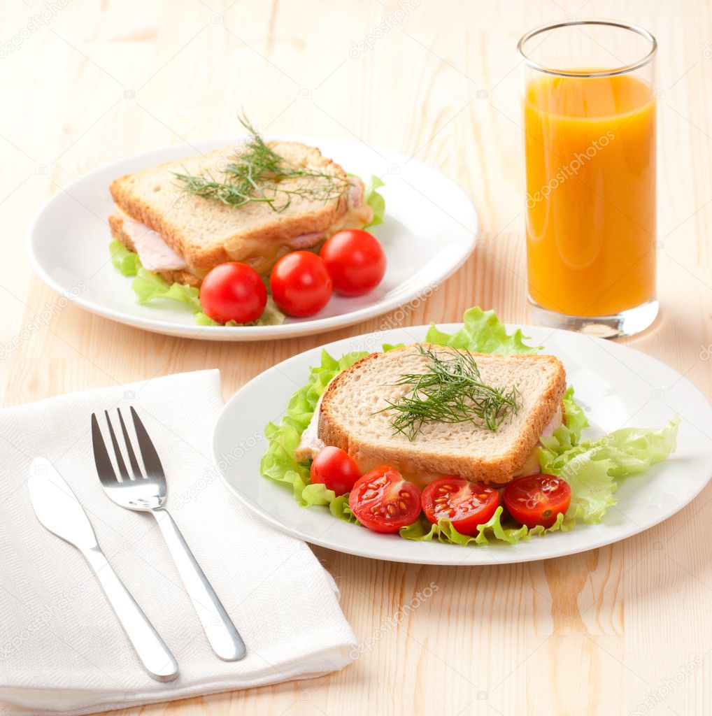 Tasty sandwiches with peach juice