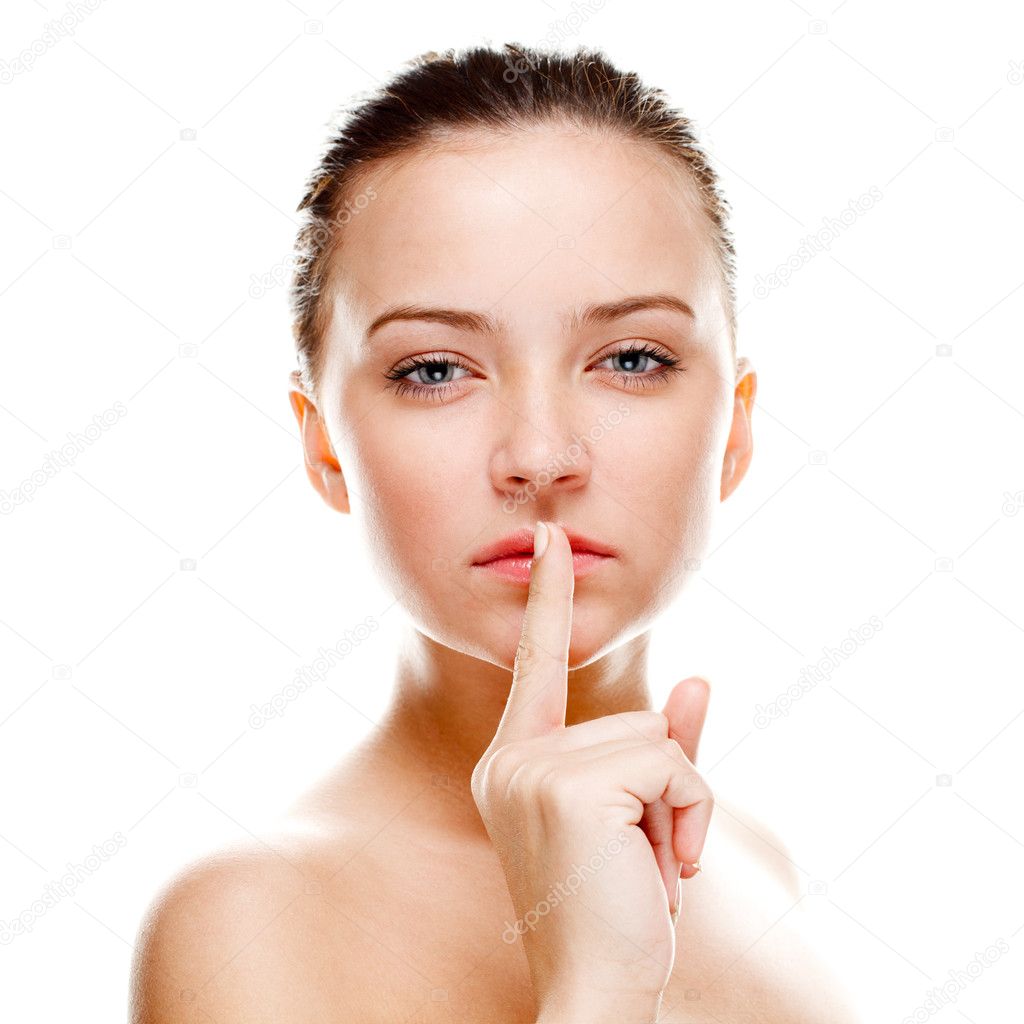 Beautiful woman making silence sign. Isolated over white. Focused on finger