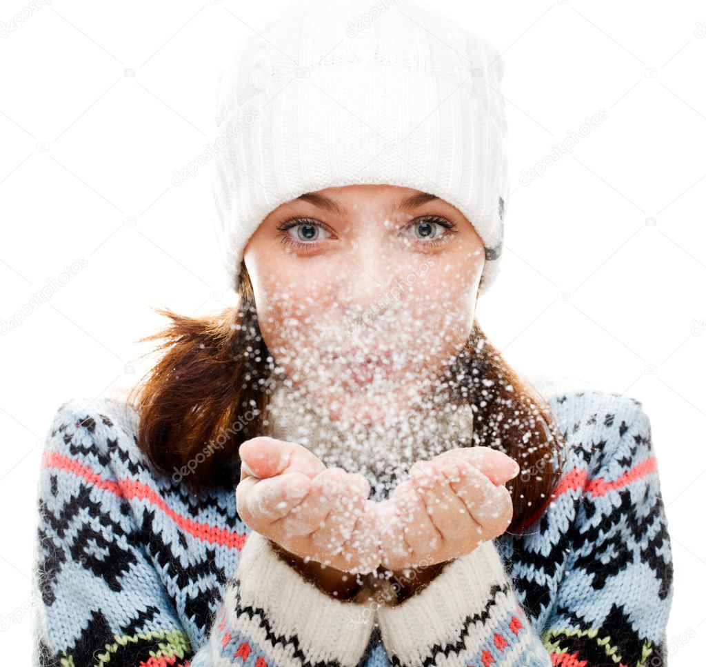 Beautiful woman blowing snow