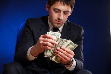 Businessman counts money clipart