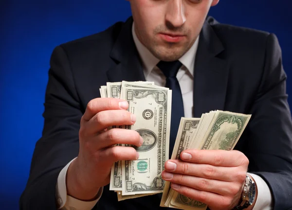 Businessman counts money — Stock Photo, Image