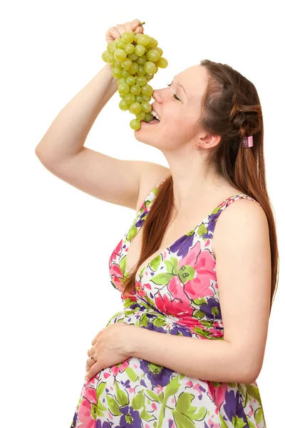 Terhes lány étkezési szőlő. — Stock Fotó
