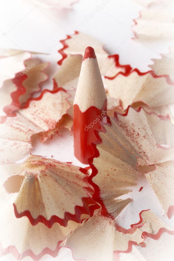 Sharpened red pencil and wood shavings