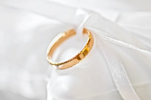 stock image Wedding ring on a satiny fabric (macro)