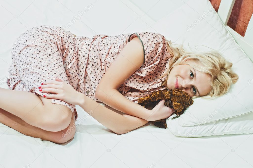A beautiful woman resting on the bed