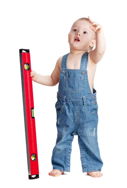 Pracovník malé dítě s úrovní — Stock fotografie