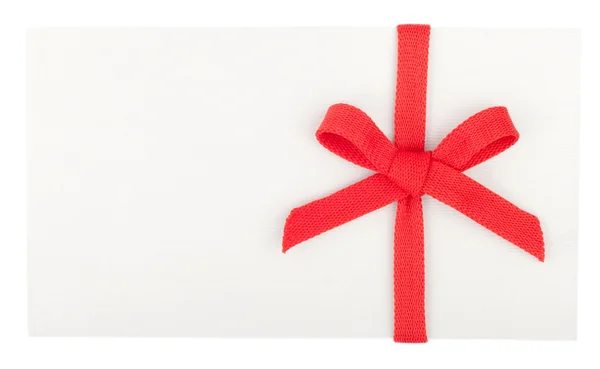 Red bow on a white box or envelope isolated on white — Stock Photo, Image