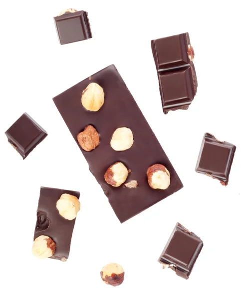 Pieces of chocolate bar with nuts on white background — Stock Photo, Image
