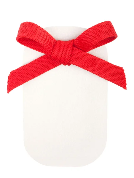 白で隔離される用紙バッジ上の赤い弓 — ストック写真