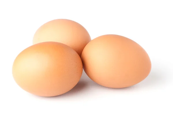 Tres huevos marrones sobre fondo blanco —  Fotos de Stock