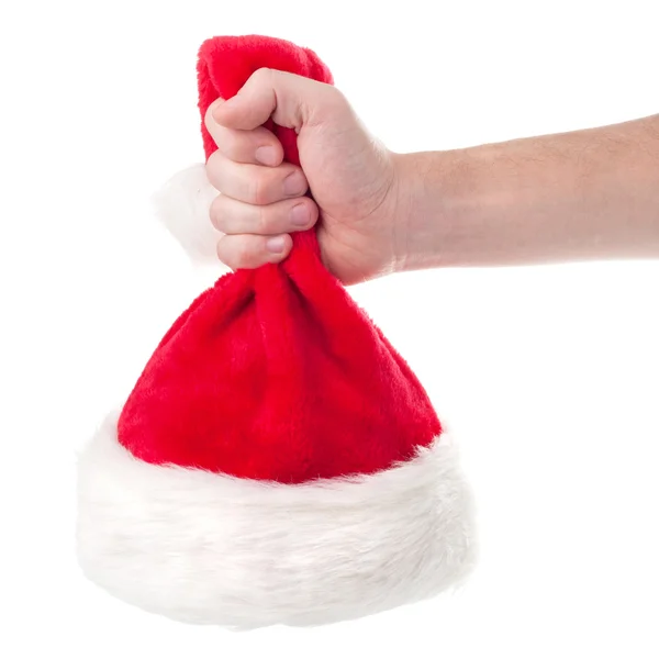 Mão segurando Papai Noel chapéu vermelho — Fotografia de Stock