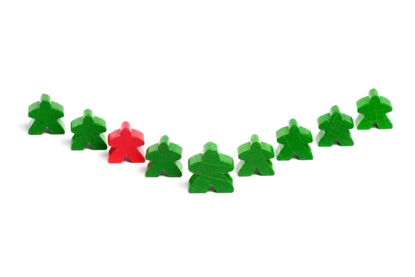 stock image Red wooden figure among green ones on white background