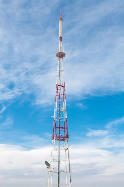 stock image Telecommunication tower with antennas against blue sky background