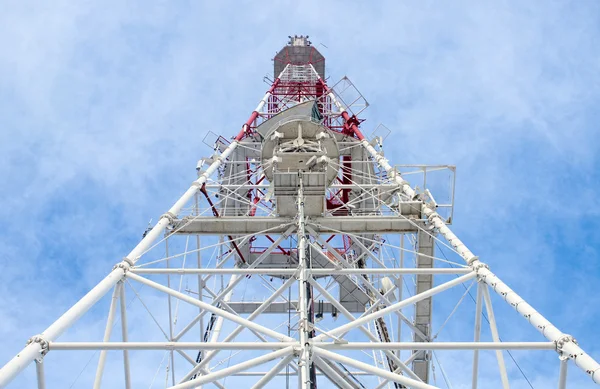 stock image Telecommunication tower with antennas against blue sky background