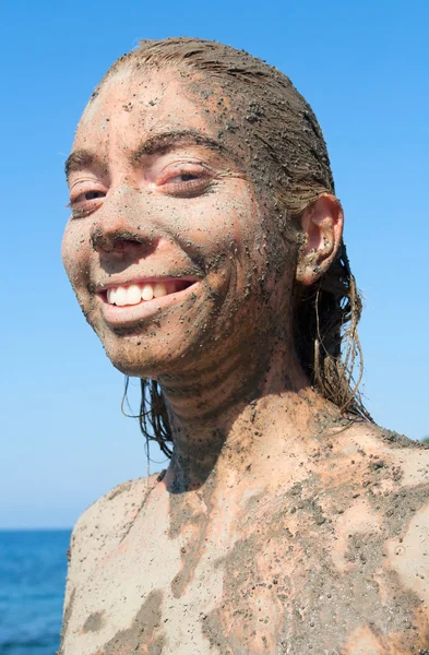 Young beautiful smiling woman getting a body mud therapy — Stock Photo, Image
