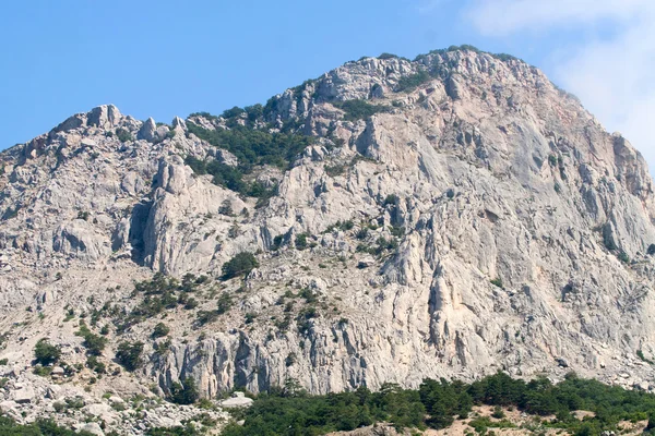 Enorme montanha rochosa contra o céu azul — Fotografia de Stock