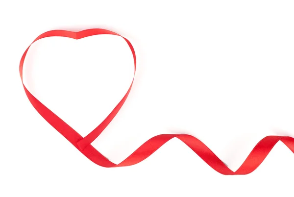 Red heart shaped ribbon on white background — Stock Photo, Image