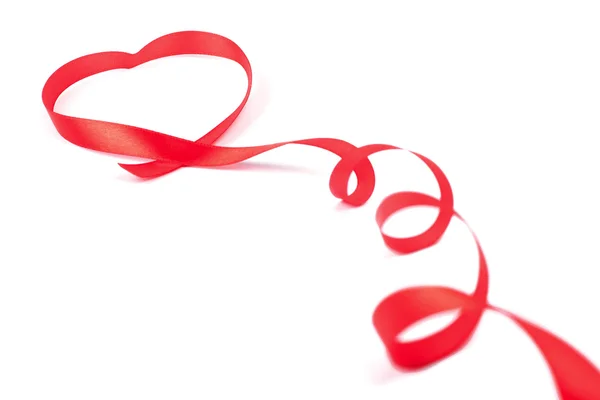Red ribbon curled in heart shape isolated on white background — Stock Photo, Image