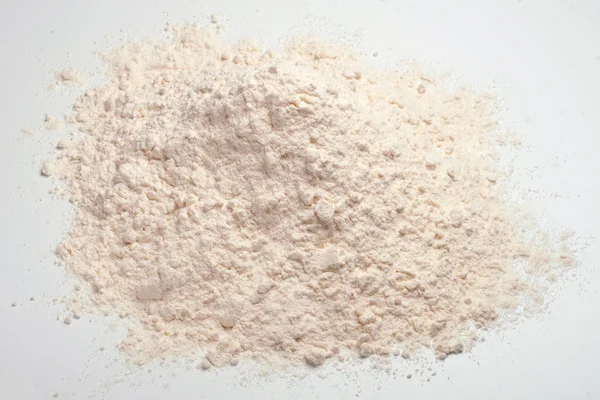 Wheat flour heap on a white background — Stock Photo, Image