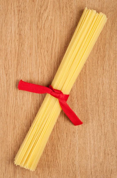 Bunch of spaghetti on wooden background — Stock Photo, Image