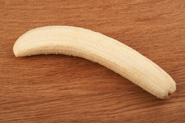 Ώριμη μπανάνα αποφλοιωμένες σε ξύλινα φόντο — Φωτογραφία Αρχείου