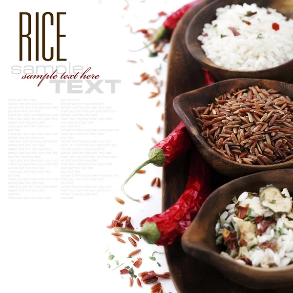 stock image Bowls of uncooked rice over white with sample text