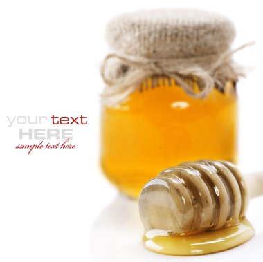 Full honey pot and honey stick over white (with sample text) clipart