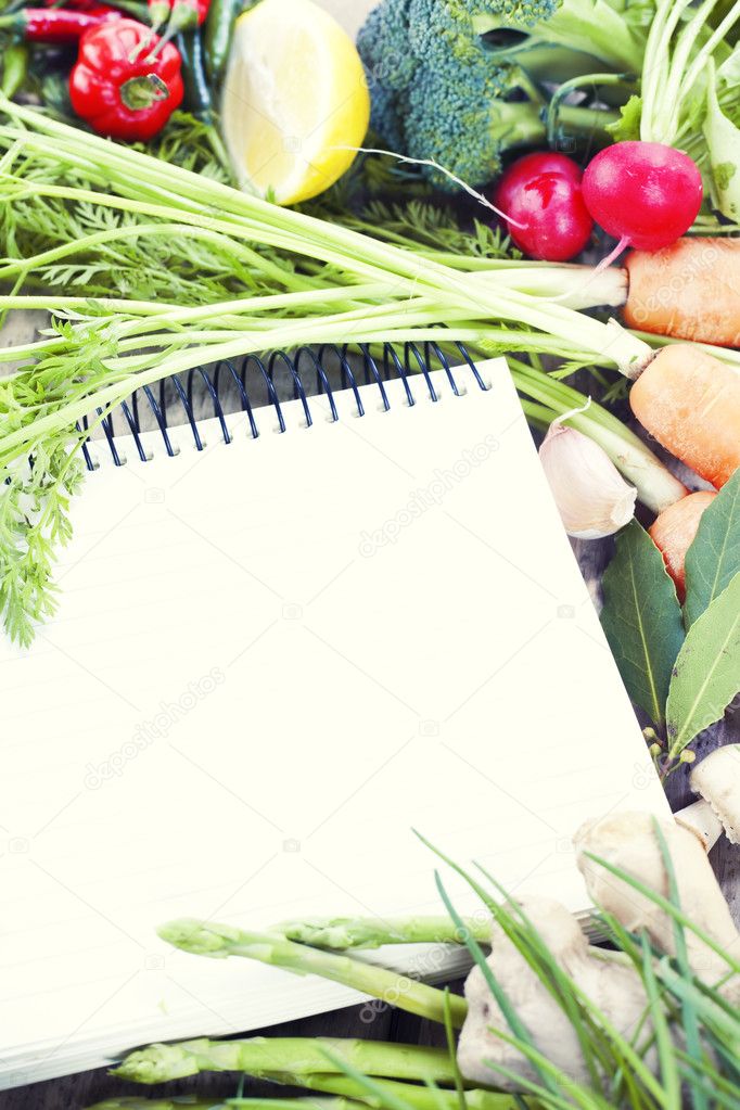 Open notebook and fresh vegetables