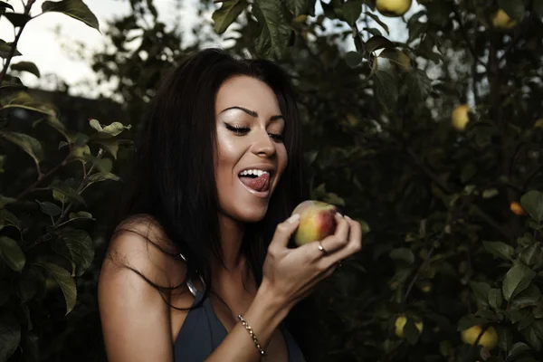 Sexual beauty dressed bikini poses in an autumn garden of apples. — Stock Photo, Image