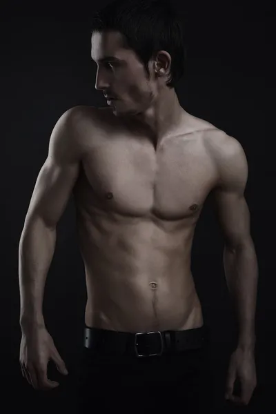 Schöne athletische kaukasische Mann auf dunklem Hintergrund — Stockfoto