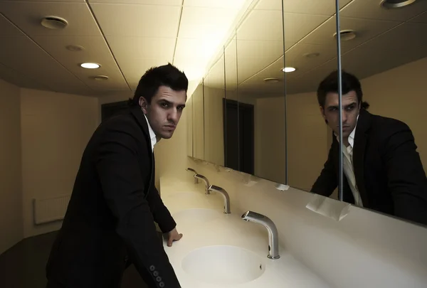 stock image Vain business man checking his looks in the mirror